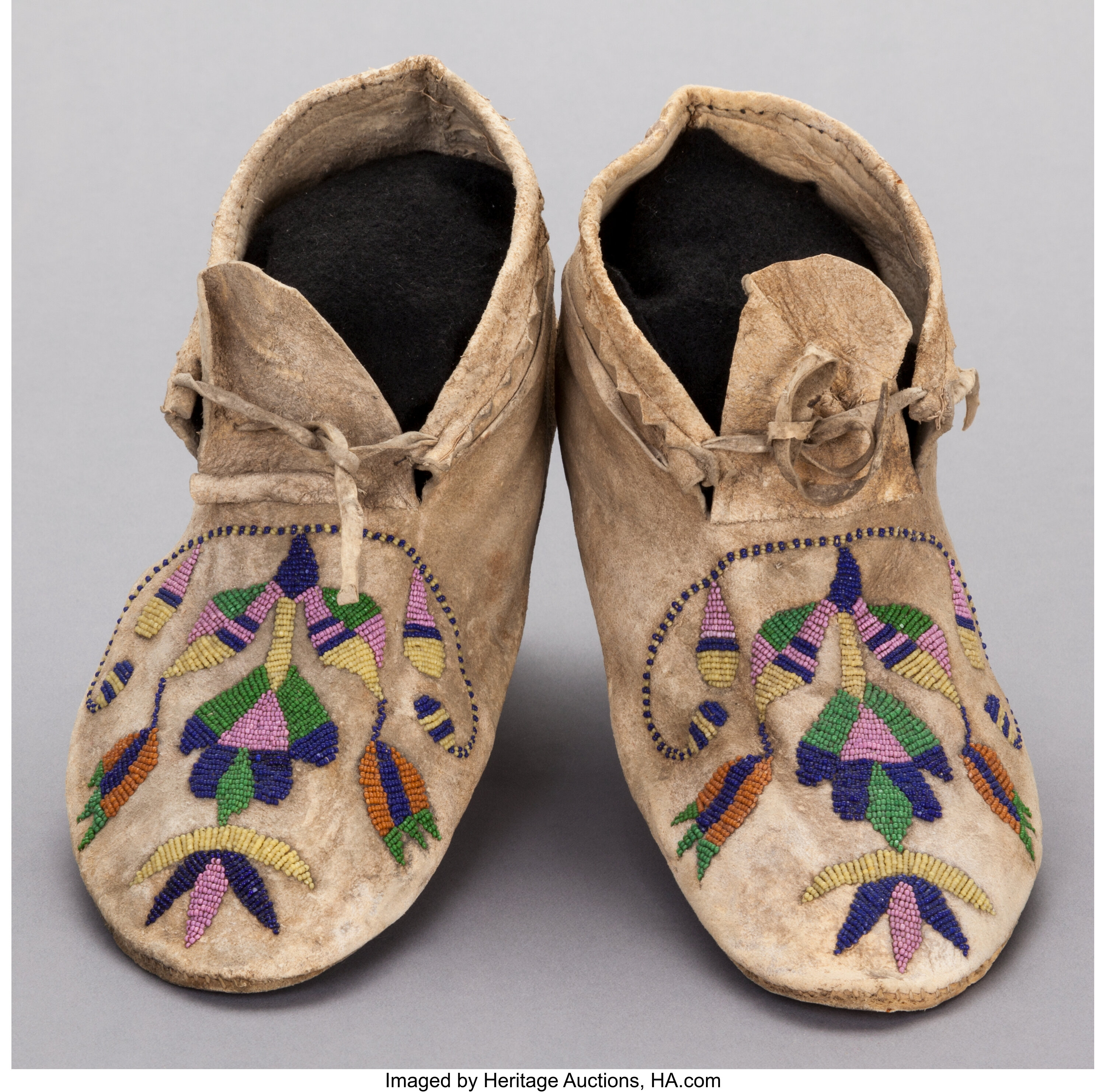 A PAIR OF SANTEE SIOUX BEADED HIDE MOCCASINS. c. 1890... (Total: 2 ...