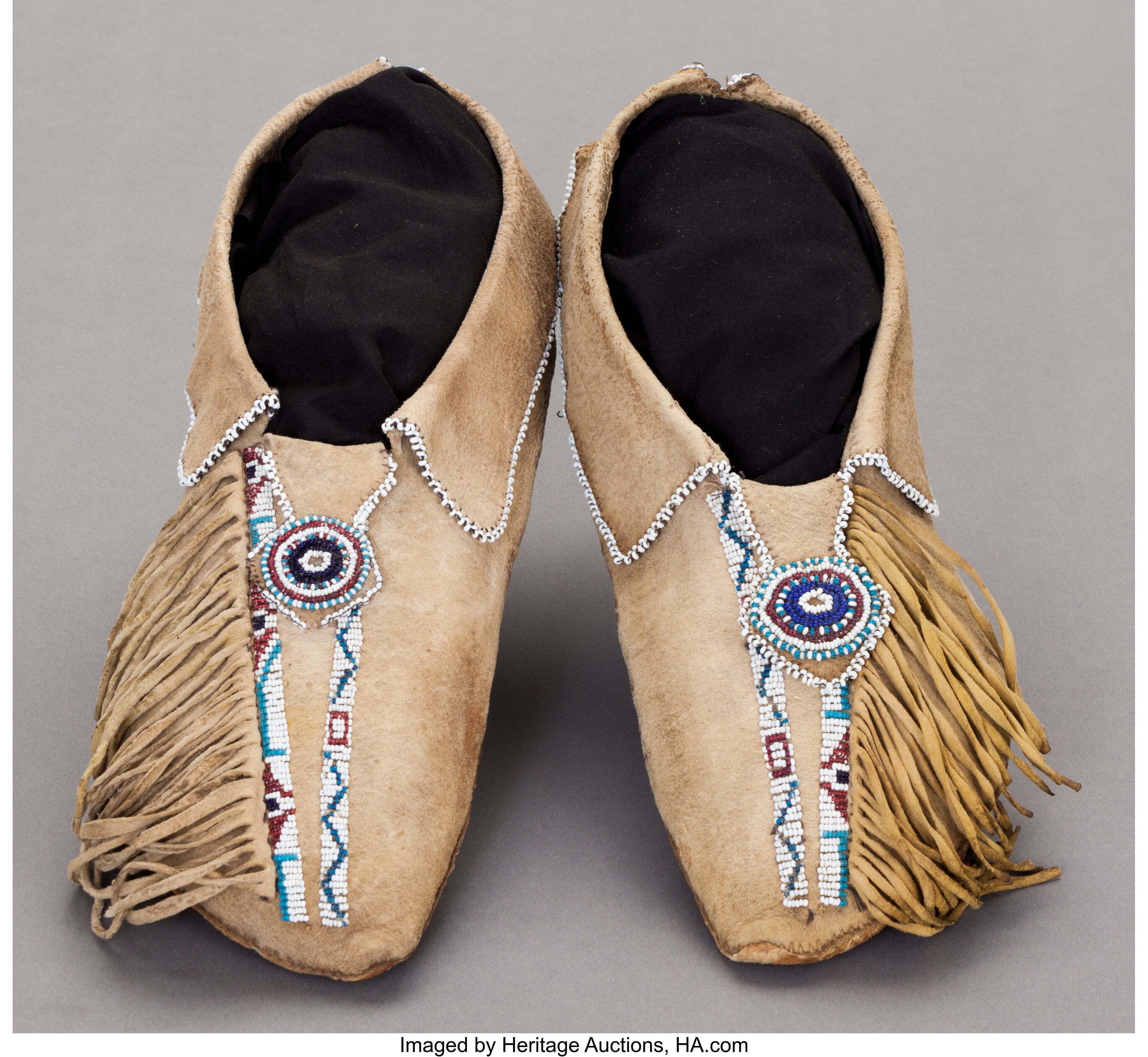 A PAIR OF COMANCHE BEADED HIDE MOCCASINS. c. 1890 American