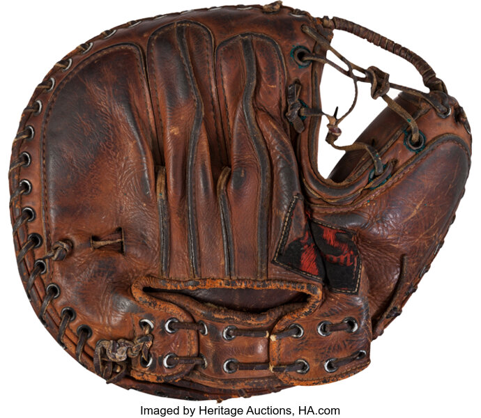 Old baseball glove and ball. An old baseball glove (1950 s Roy