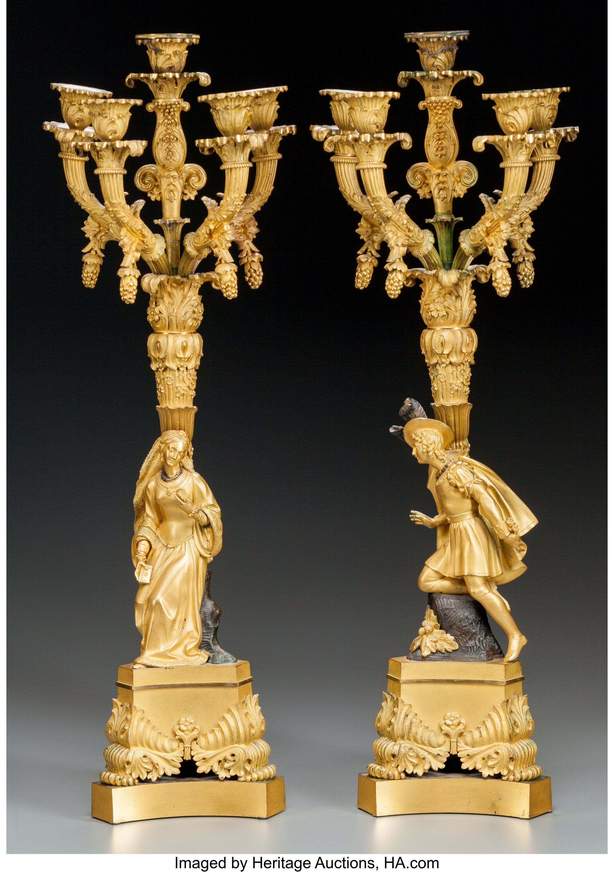 A PAIR OF FRENCH GILT AND PATINATED BRONZE EIGHT LIGHT FIGURAL