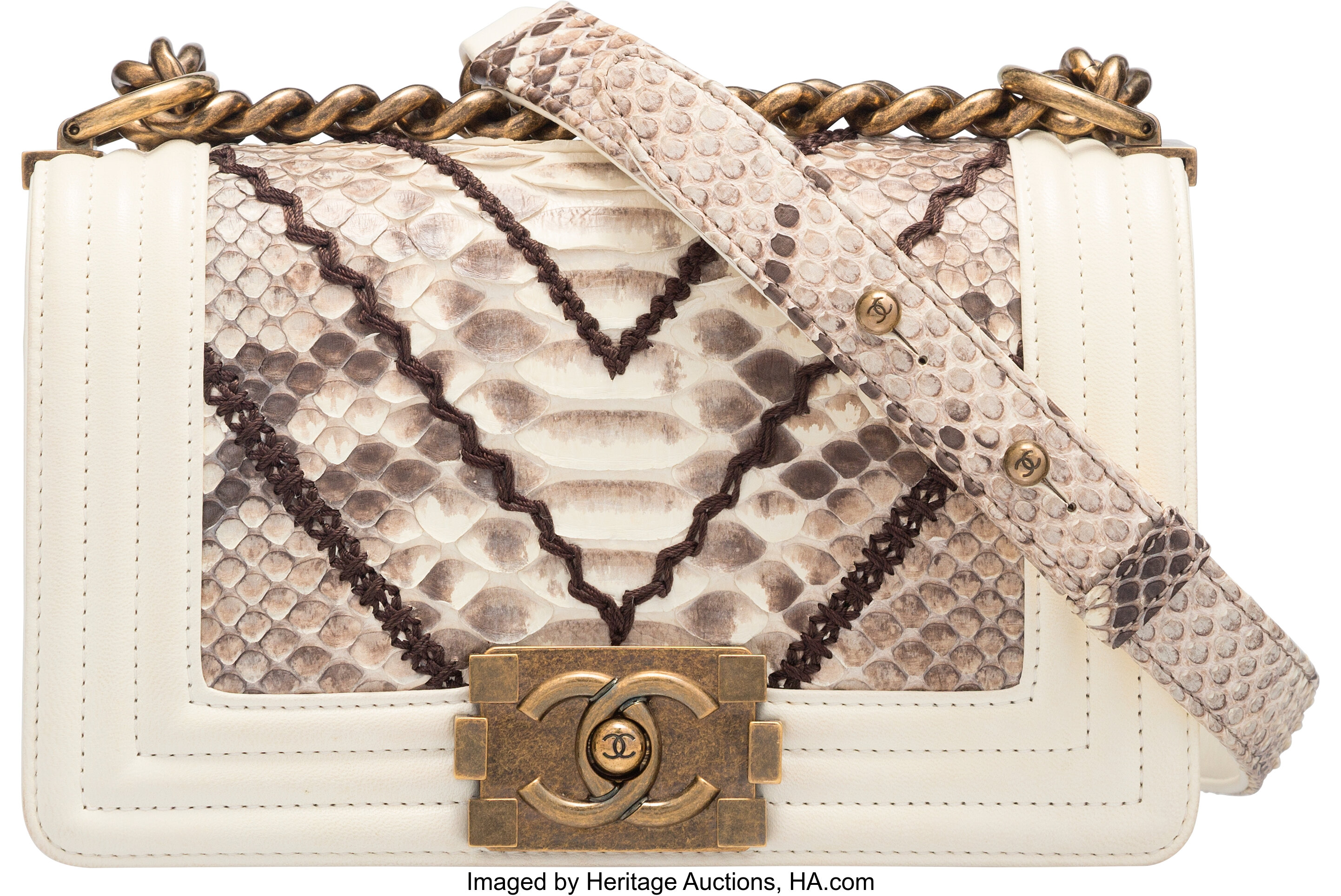 The accent of a Chanel designer tote bag. Two intertwined letter Cs hanging  from the strap as it threats through the Belt loop, itself marked 'Chanel'  Stock Photo - Alamy