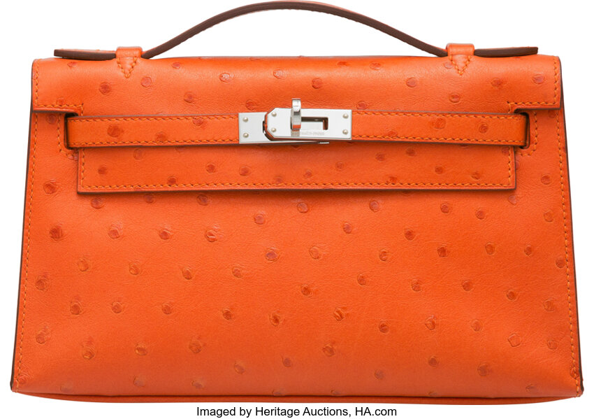 A TANGERINE OSTRICH KELLY POCHETTE WITH PALLADIUM HARDWARE