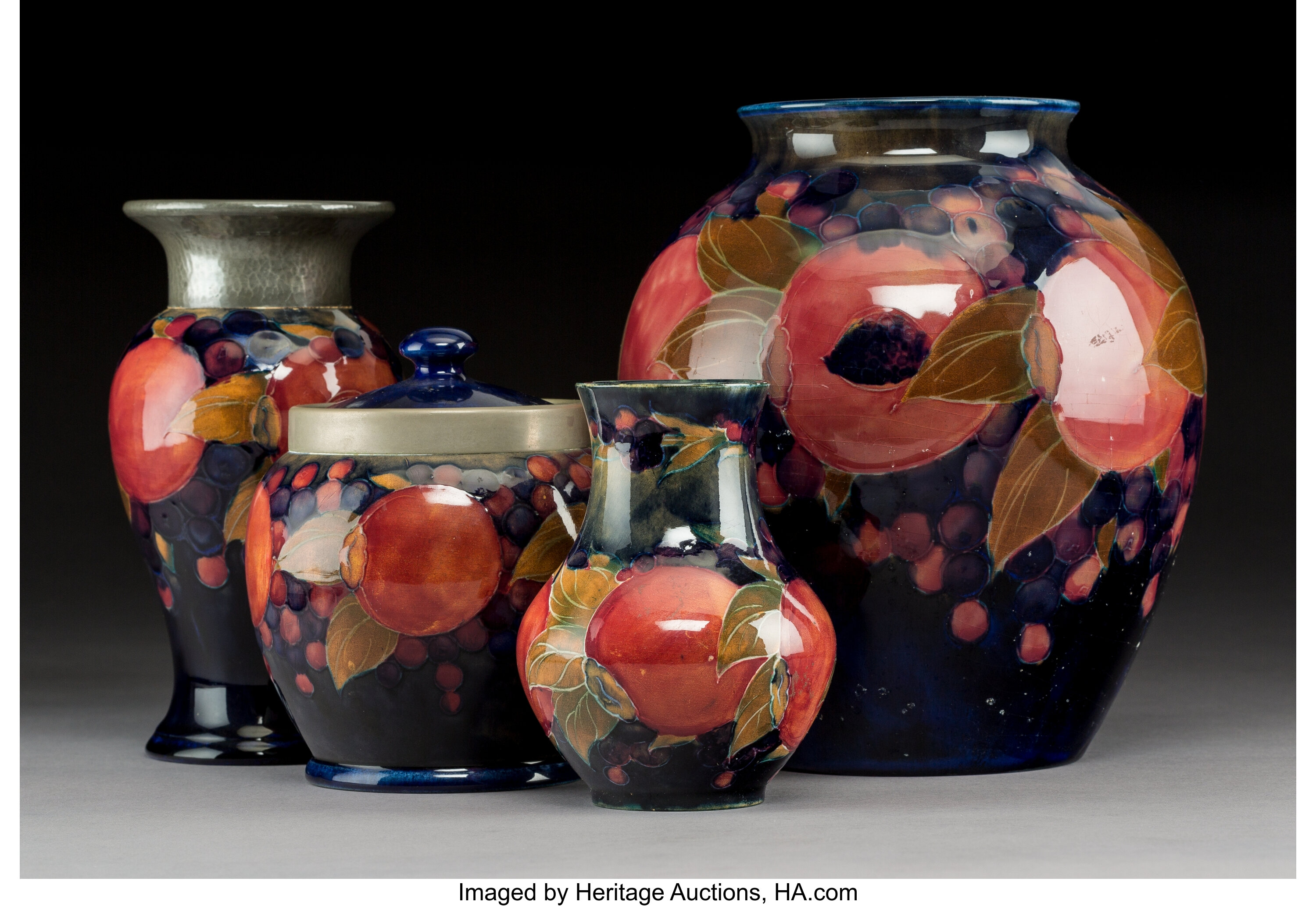 Four Moorcroft Pottery Pomegranate Pattern Vessels Circa 1930 And