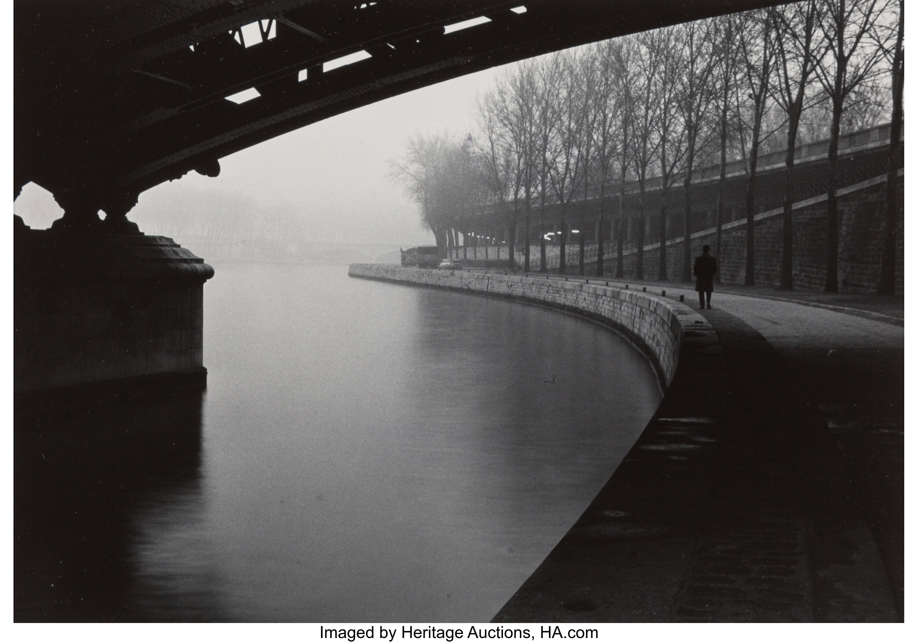 Willy Ronis (French, 1910-2009). Man Walking Along the Seine, | Lot ...