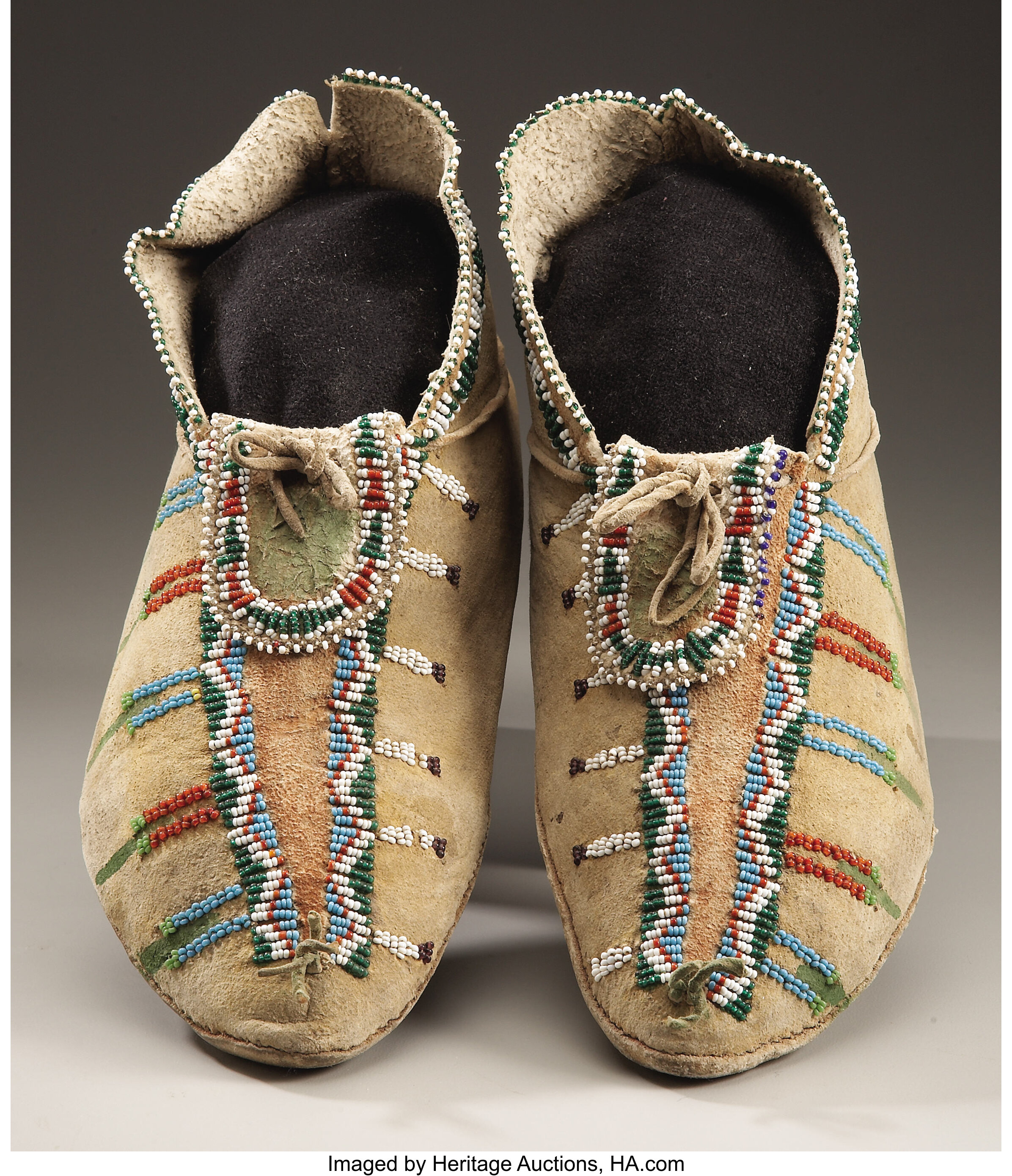 A PAIR OF APACHE BEADED HIDE MOCCASINS. c. 1880... (Total: 2 Items ...