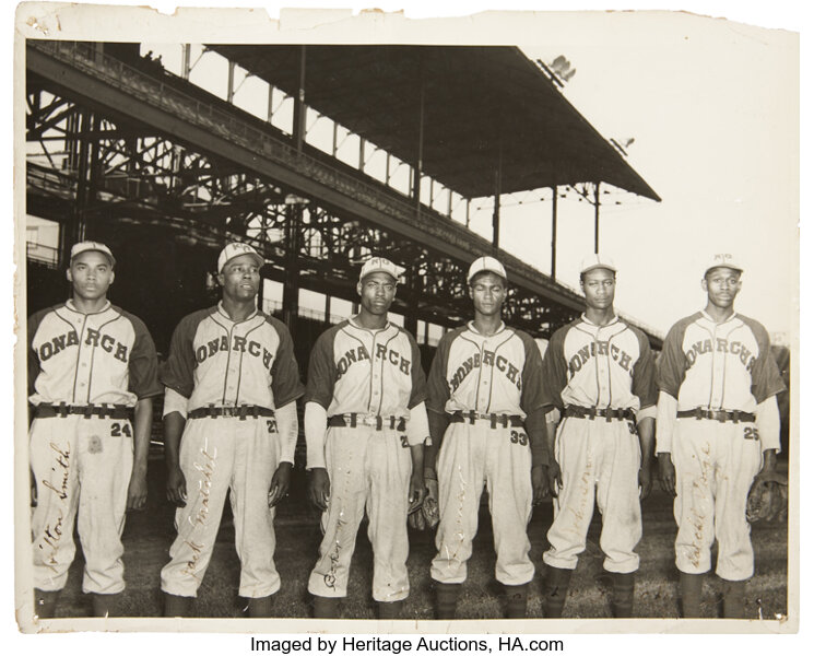 Untitled photo shows: Satchel Paige, in the Kansas City Monarchs uniform at  a baseball game]
