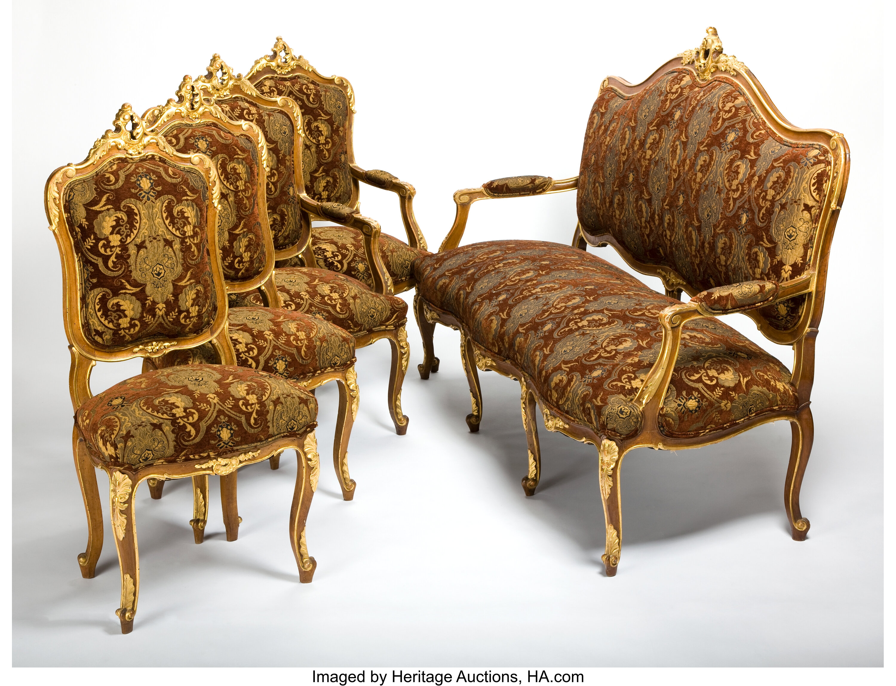 A Louis XV gilt-wood salon suite comprising four armchairs and a